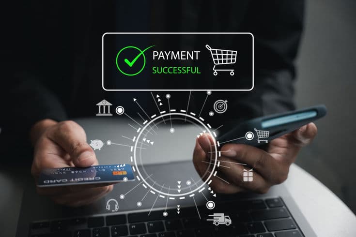 A shopper holding a bank card and phone as a payment successful confirmation appears